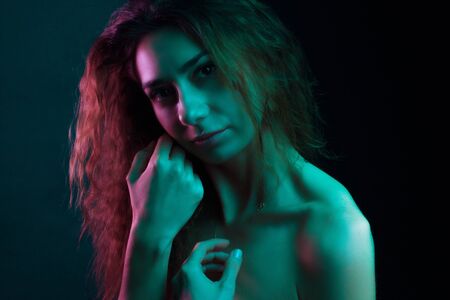 High Fashion model woman in colorful bright lights posing in studio, portrait of a beautiful girl. Artistic colorful design. Party concept,の写真素材