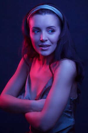 Fashionable Artistic Portrait Of A Beautiful Female Model In Bright Lights. in underwear. arms...