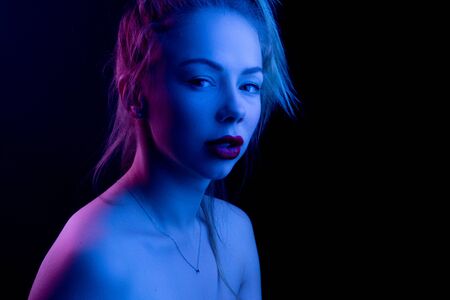 High Fashion model woman in colorful bright lights posing in studio, portrait of a beautiful girl. Artistic colorful design. Party concept,の写真素材