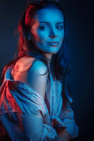 Fashionable Artistic Portrait Of A Beautiful Female Model In Bright Lights. Color gel photographyの写真素材