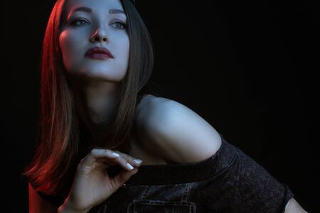 Fashionable Artistic Portrait Of A Beautiful Female Model In Bright Lights. Color gel photographyの写真素材