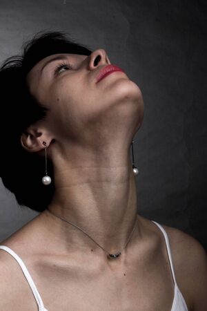 brunette with short hair. Studio portrait in white t-shirt. he lifted his chin heads strongly up
