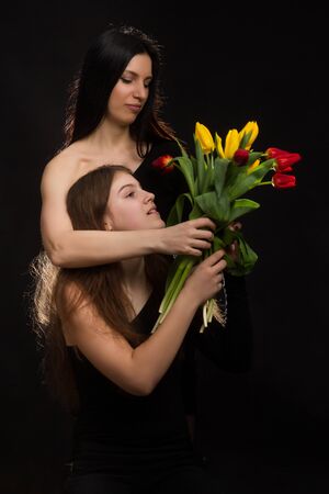 Portrait of girl and woman with tulips in the Studioの写真素材