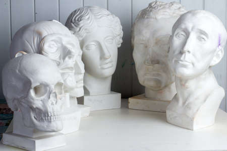 Belarus, Minsk, 16.04.2020 group classical plaster head bust against a white, old, worn wall....