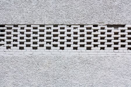 White brick wall background. Neutral texture of a flat brick wall close-up.の写真素材