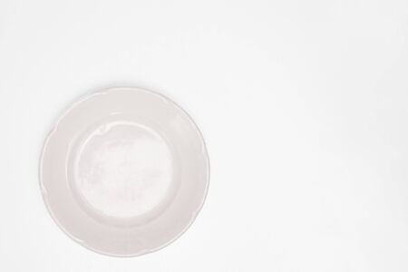 White plate on a white background of isolate. Copyspace