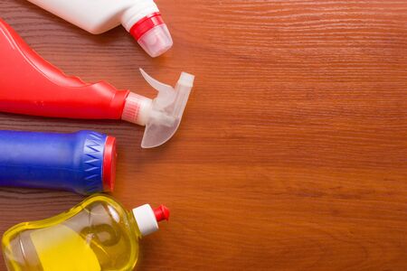 Set for cleaning various surfaces in the kitchen, bathroom and other areas. Copyspace for text or logo on a wooden background. The concept of cleaning services, house cleaning Flat layの写真素材