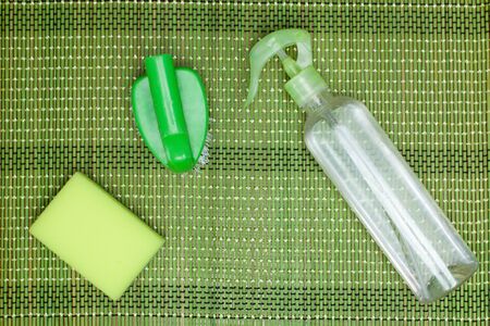 Set for cleaning various surfaces in the kitchen, bathroom and other areas. Copyspace for text or logo on a green Mat background. The concept of cleaning services, house cleaning Flat layの写真素材
