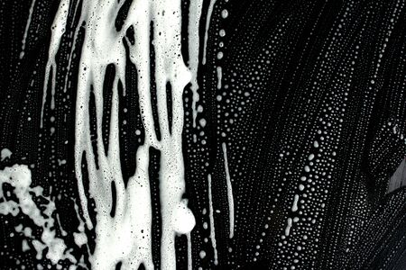 The texture of the soap foam stains marks on a black background. The concept of cleaning, and disinfection..の写真素材