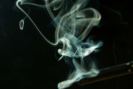 soldering iron with smoke from the sting of burning rosin. Photo on a black background