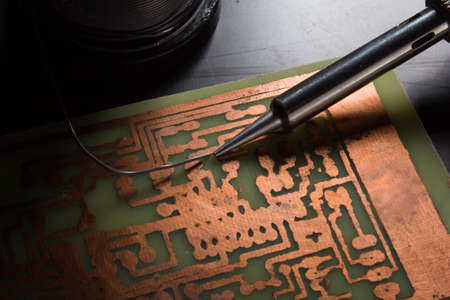 use a soldering iron to solder the electronic part to the Board. Computer repair. Macrophotography.