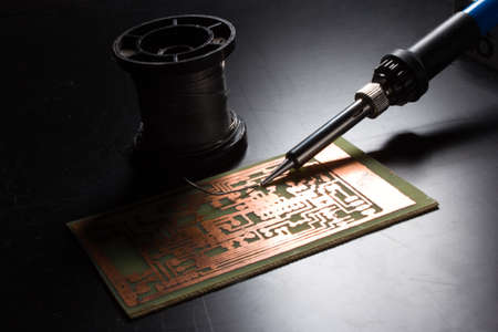 Soldering iron and solder to electronic part to the Board.Computer repair. Macrophotography.