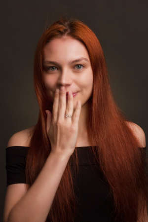 portrait of a beautiful red haired young positive woman