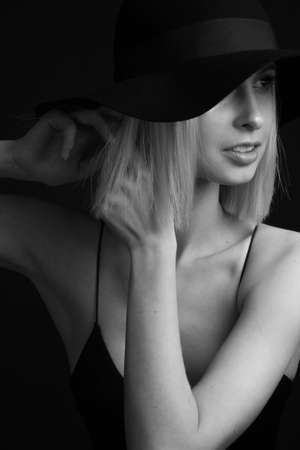 Black and white portrait blondes on black background in a hat and Tank Top With Thin Strapsの写真素材