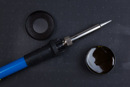 Soldering iron, and rosin, on a black backgroundの写真素材