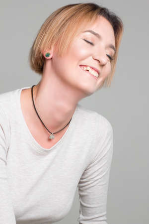 portrait of a blonde girl on a white background, in white clothes