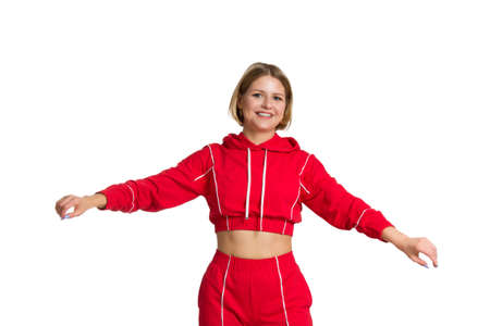 a young fit woman with short hair, wearing a red tracksuit, isolated on a white background.の写真素材