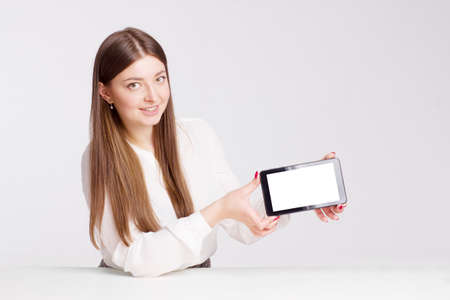portrait of a young businesswoman in a white shirt. holds a digital tablet in his hands. mockup,...
