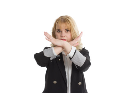 woman in a black business suit, Isolate on a white background. She stretched out her arms and crossed them, palm forward. Denial is a gesture of refusal. Negative attitude, disagreement.の写真素材