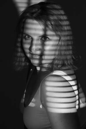 artwork portrait of an overweight woman. model posing in light of projector. Black and white retro monochrome photographyの写真素材