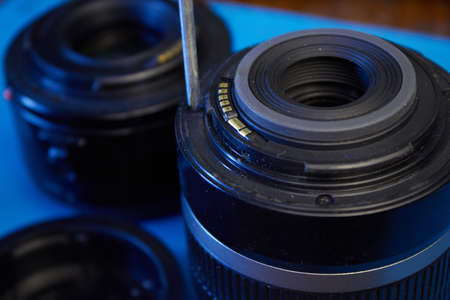 We disassemble the lens with a screwdriverの写真素材