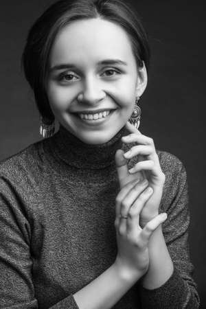 black and white studio portrait a Young woman with short brown hair, in a gray sweaterの写真素材