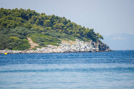 Rocky coastline and beautiful clean water in Halkidiki Kassandra in Greeceの写真素材