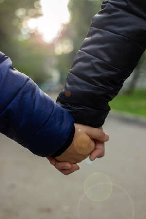 children holding hands in the yard