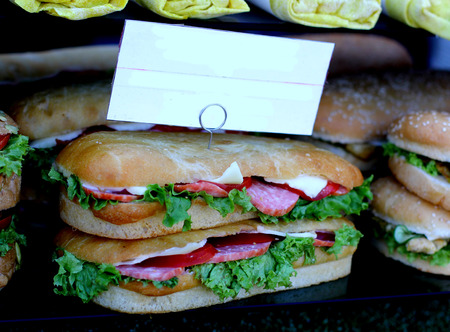 Tasty Pepperoni salami Sausage burger sandwich with lettuce and salad served as fast food with blank copyspace price labelの写真素材