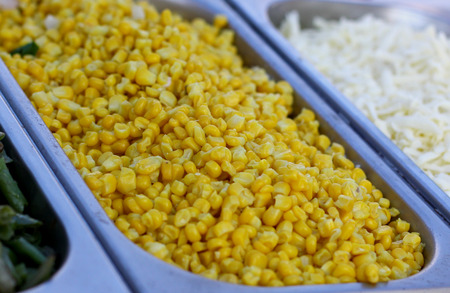 Fresh vegetable salad from yellow maize corn beans on a fast food sale plate, selective focus, close-upの写真素材