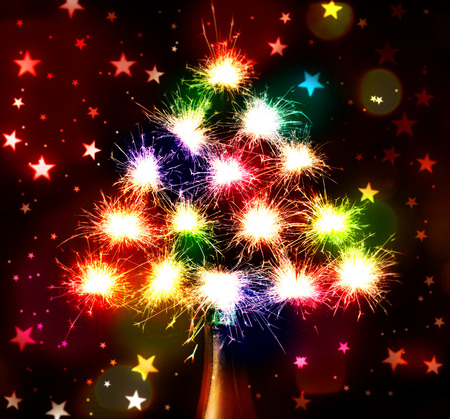 Christmas New Year's tree form fireworks sparks Bokeh blured on stars dark background from the bottle champagneの写真素材