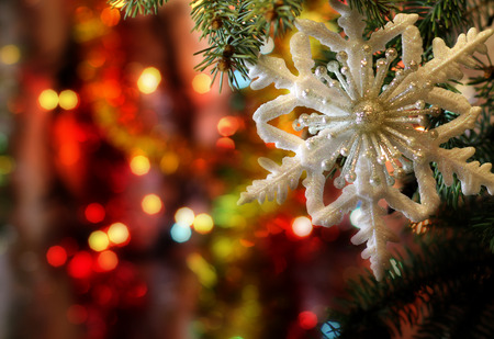 Style New Years and Christmas Eve celebration background with a Christmas snowflake decoration elegant arrangement clock counting down to midnight, tree brunch. Copyspace. Bokeh light garland.の写真素材