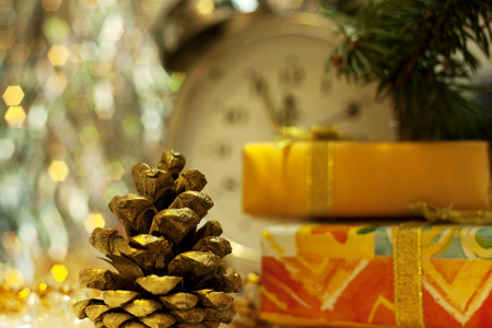 Christmas and New Year`s vintage clock showing five to midnight. Gold gift box with gold bow, retro...