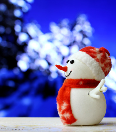 Christmas and New Year`s background with Snowman drags a car on snow forest bokeh. Foreground ready for product montage. Copyspace for sale price and item description. Concept market banner, poster.の写真素材