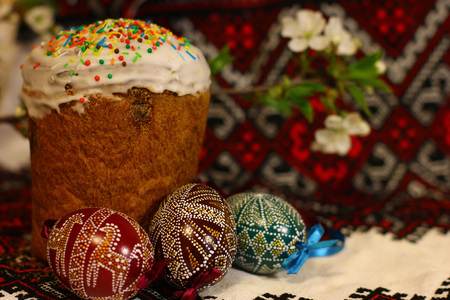 Easter decorated eggs and homemade breads on the traditional tablecloth background. Spring of...