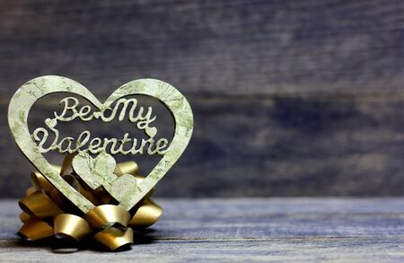 Decorative hand made heart on wooden background. Be My Valentine inscription. Heart of decoupage...