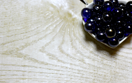 Blue glass balls on wooden background. Concept with big copyspase for hand crafts or DIY illustration.の写真素材