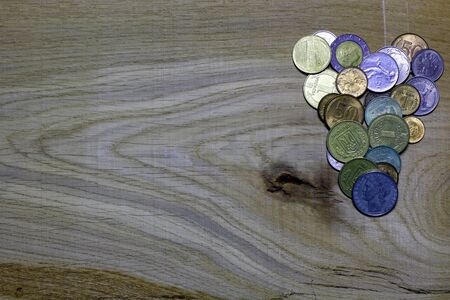 Heart of coins on wooden background. Love card for Valentine's day.の写真素材