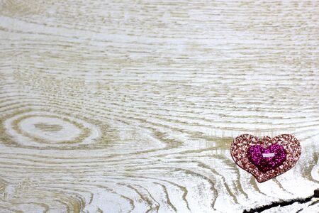 Shine plastic hearts on light wooden background. Love card for Valentine's day. Concept with big copyspase for hand crafts or DIY illustration.の写真素材