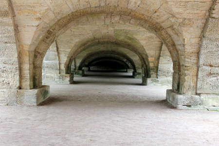 stone arch tunnel running into the distanceの写真素材