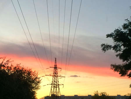 bright orange sunset and power linesの写真素材