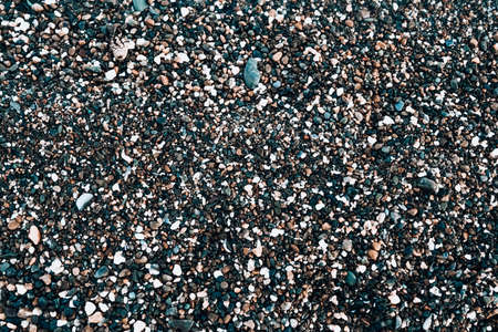 many pebble stones ashore background textureの写真素材