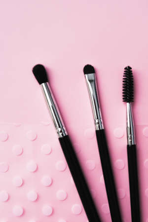 cosmetic brushes for makeup on a pink background, fashion, beauty