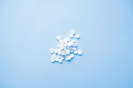 many white pills on a light background, medicine