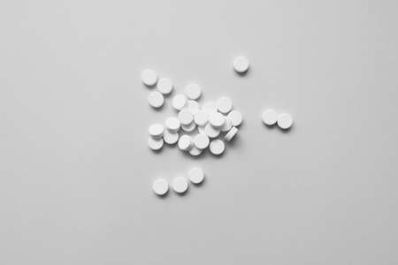 many white pills on a light background, medicineの写真素材