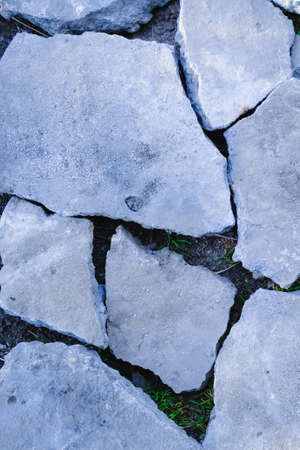 pieces of gray concrete on the ground, background and pattern