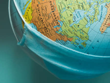 protective medical mask on a globe close-upの写真素材