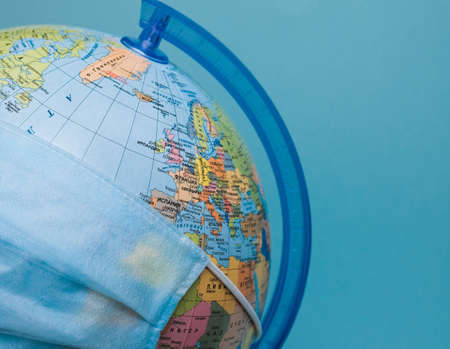 protective medical mask on a globe close-up