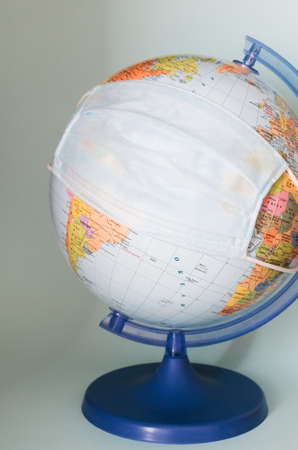 protective medical mask on a globe close-up