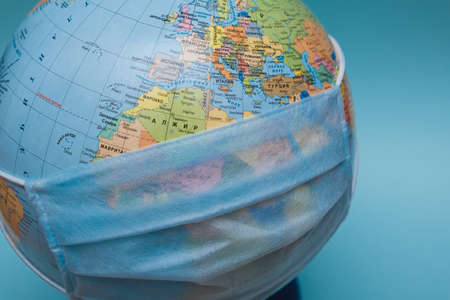 protective medical mask on a globe close-upの写真素材